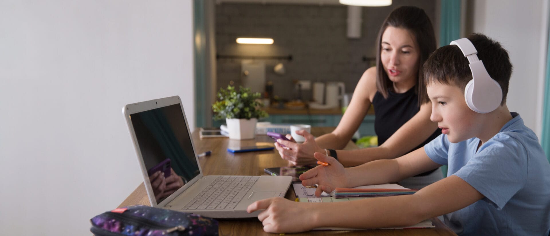 mother and her son working together with their laptop